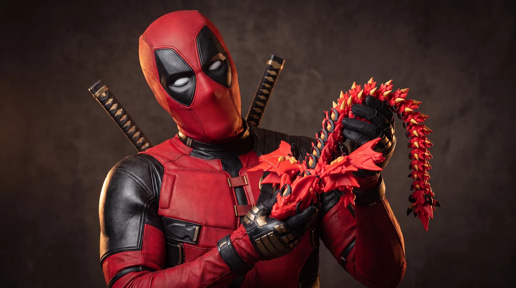The Dallas Deadpool holding the articulated Deadpool Dragon